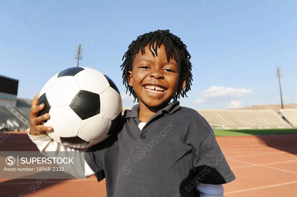 Young boy with football, Super Stadium, Pretoria, Gauteng Province, South Africa