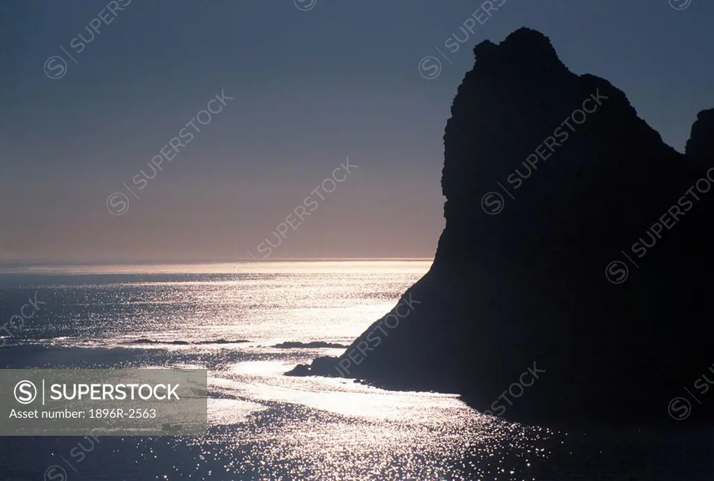 Scenic View of the Sun Setting over the Ocean Behind the Hout Bay Sentinel  Hout Bay, Western Cape Province, South Africa