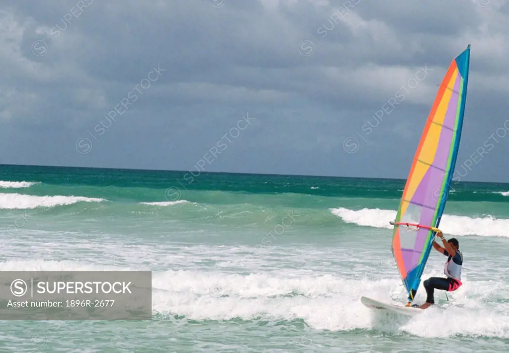 Windsurfer Riding Shore Breakers with Dark Clouds in Background  Muizenberg, Western Cape Province, South Africa