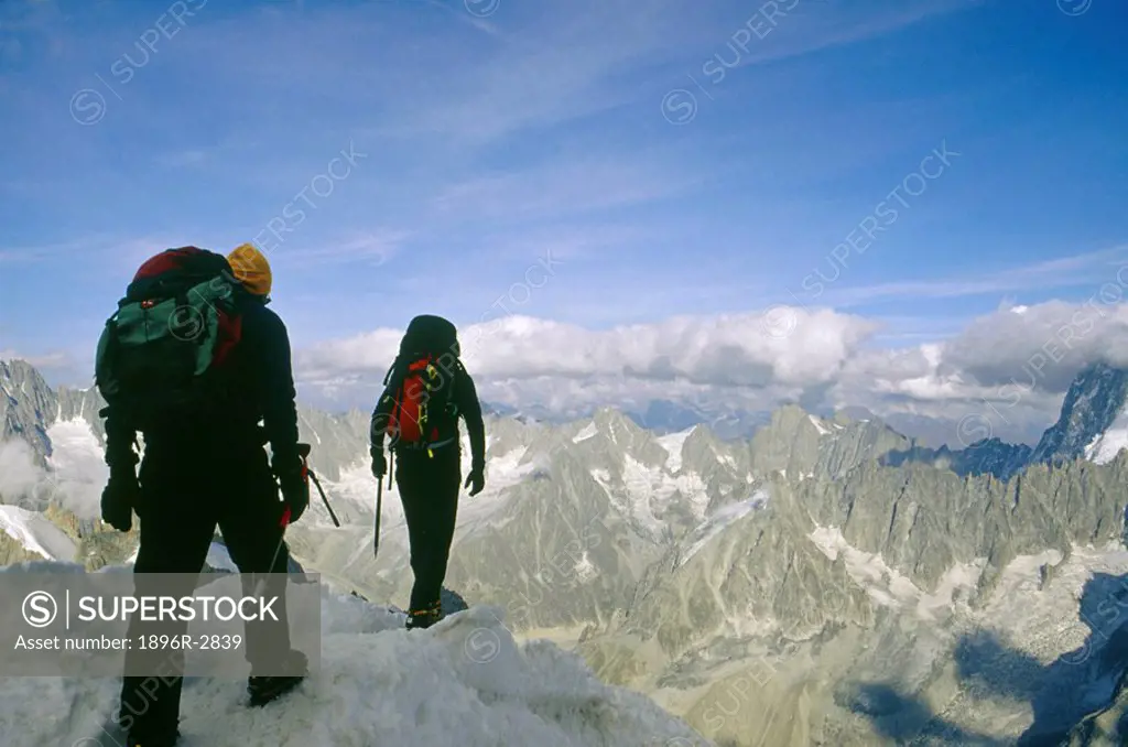 Hikers Crossing L´Aiguille du Midi - 3842m Rocky Outcrop  Mont Blanc Mountains, French Alps