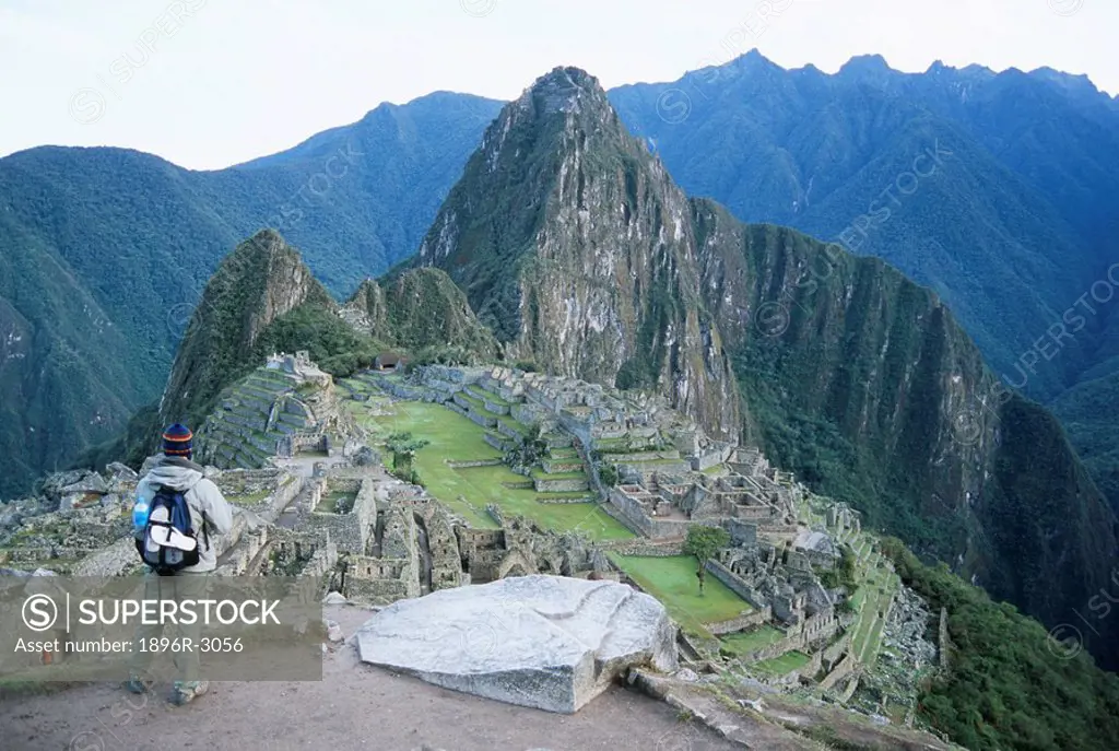Backpacker Looking Down on the Ancient Inca Ruins  Machu Picchu, Peru, South America