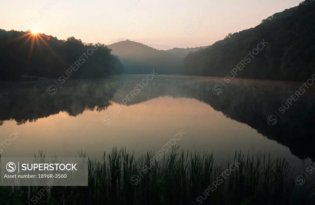 Scenic View of Sunrise Over Lake with Mountains Reflected in the Water  Lake Brown, Indiana State, United States of America