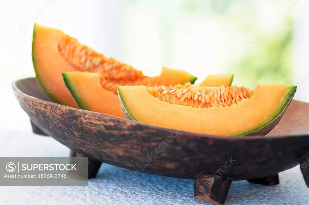 Cantaloupe Slices in a Wooden Bowl  Studio Shot