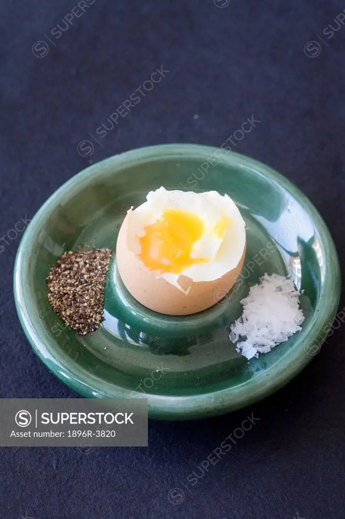 Overhead View of a Soft Boiled Egg in a Green Ceramic Egg Holder with Salt and Pepper on the Side  Studio Shot