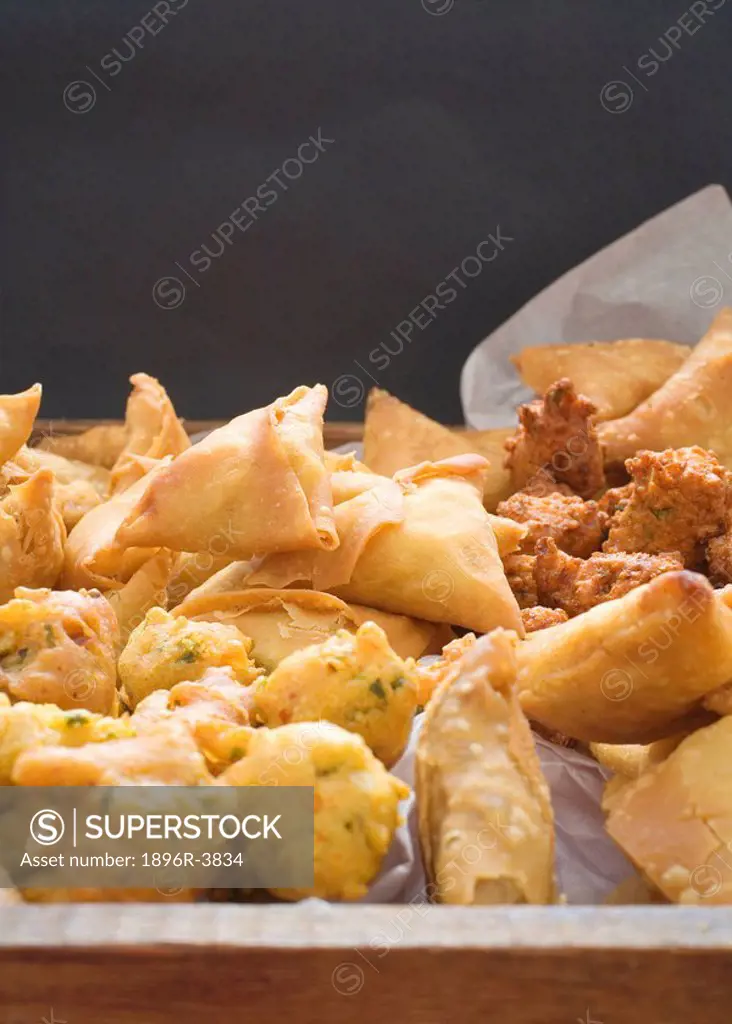 Elevated View of a Tray with a Selection of Samosas and Chilli Bites  Studio Shot