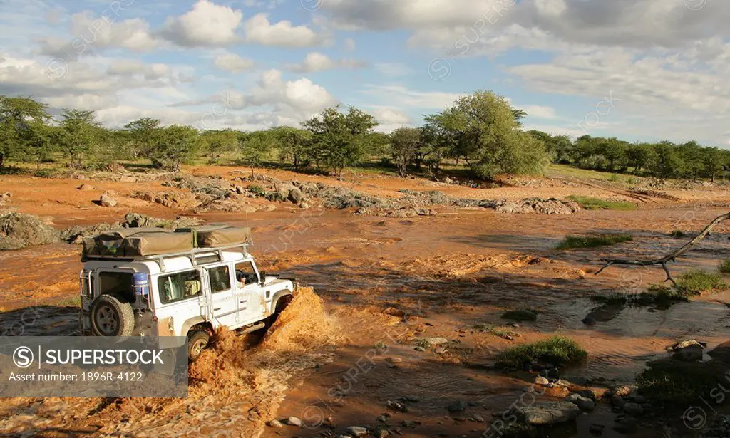 4X4 Vehicle Crossing a Muddy River in Flood  Namibia