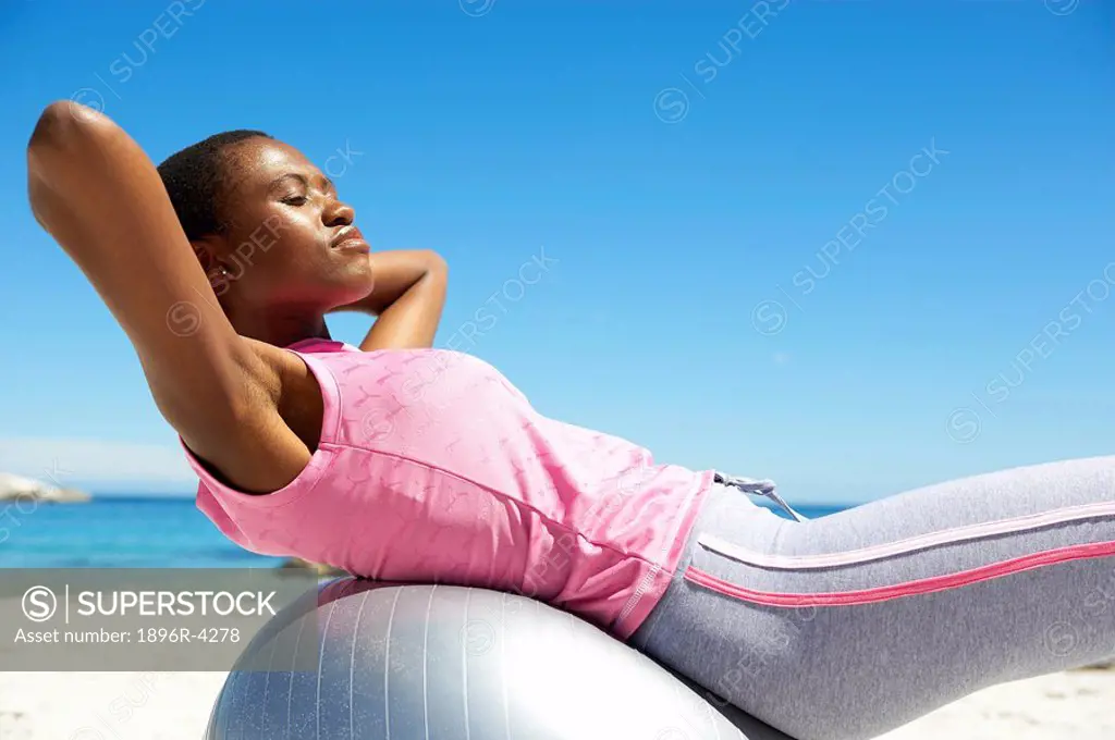 African Woman Exercising on the Beach - Side View  Cape Town, Western Cape Province, South Africa