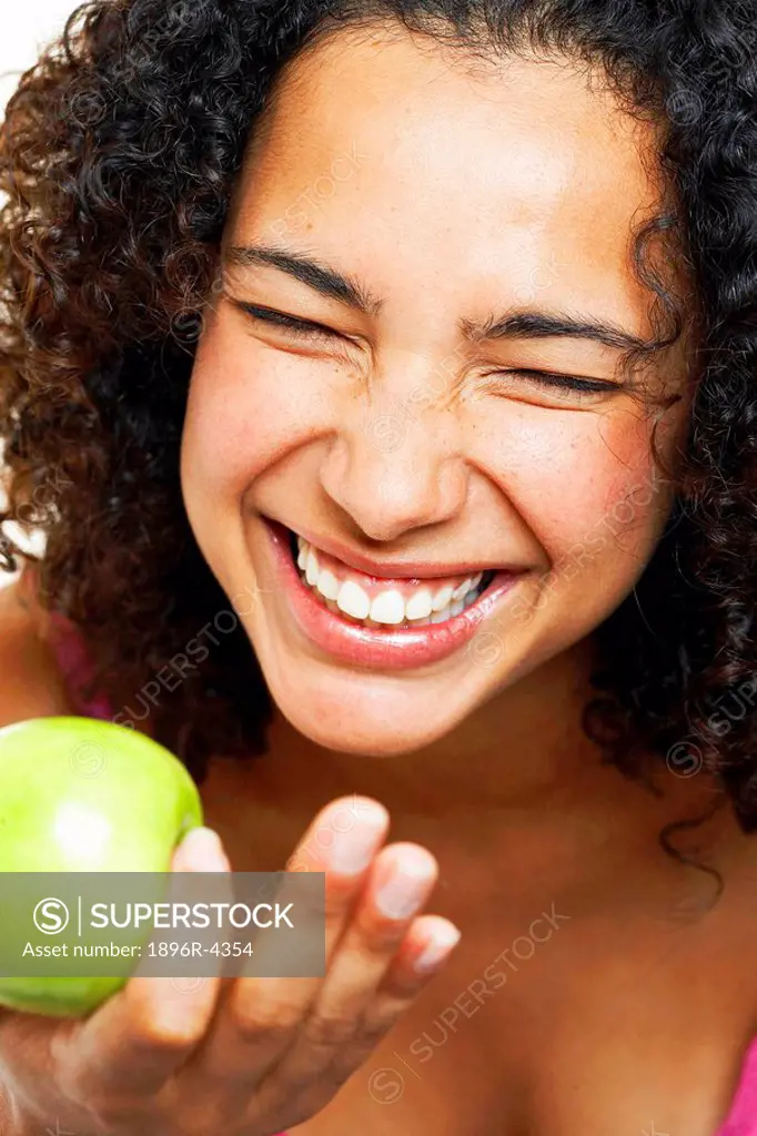 Portrait of an African Woman Holding a Fresh Apple, Laughing  Cape Town, Western Cape Province, South Africa