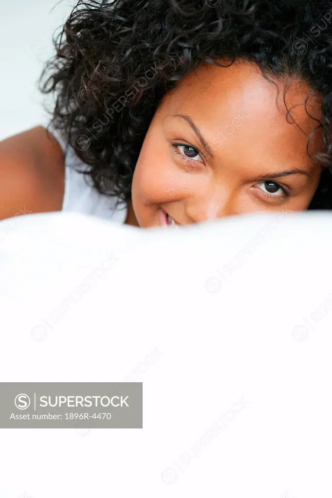 Portrait of a Mixed Race Woman on a Bed  Cape Town, Western Cape