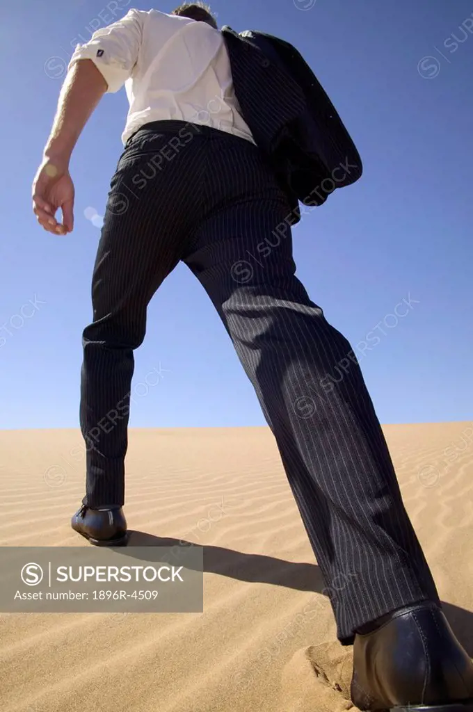 Businessman in a Suit Walking in a Desert - Rear Low Angle View  Namibia
