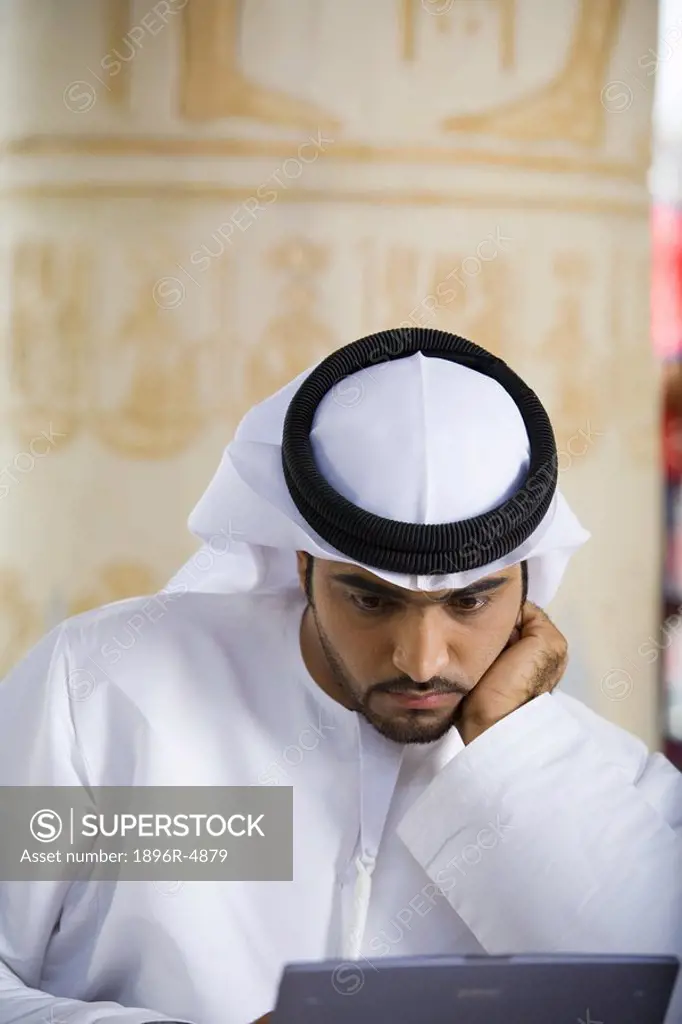 Arab Business Man Focusing on Work in Front of Laptop Computer  Dubai, United Arab Emirates