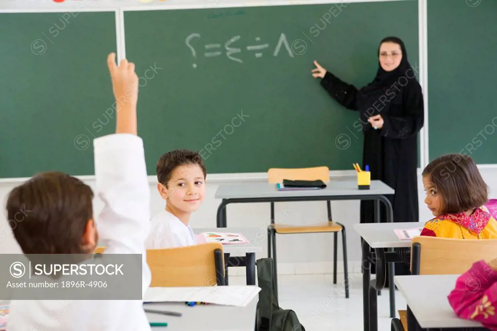Students Listening to Teacher in Front of Blackboard  Dubai, United Arab Emirates