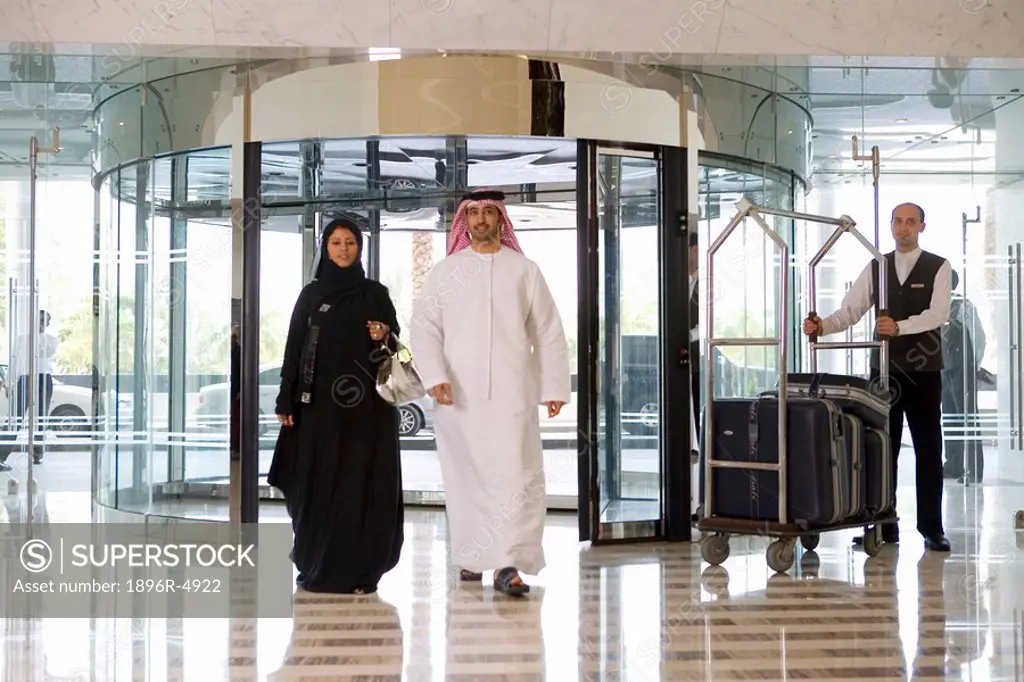 Arab Couple Entering Hotel Lobby  Dubai, United Arab Emirates