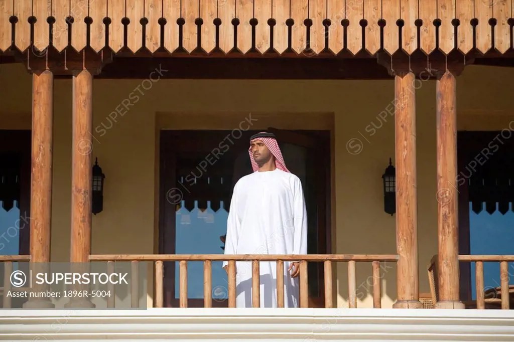 Arab Man Standing on Balcony, Low Angle View  Dubai, United Arab Emirates