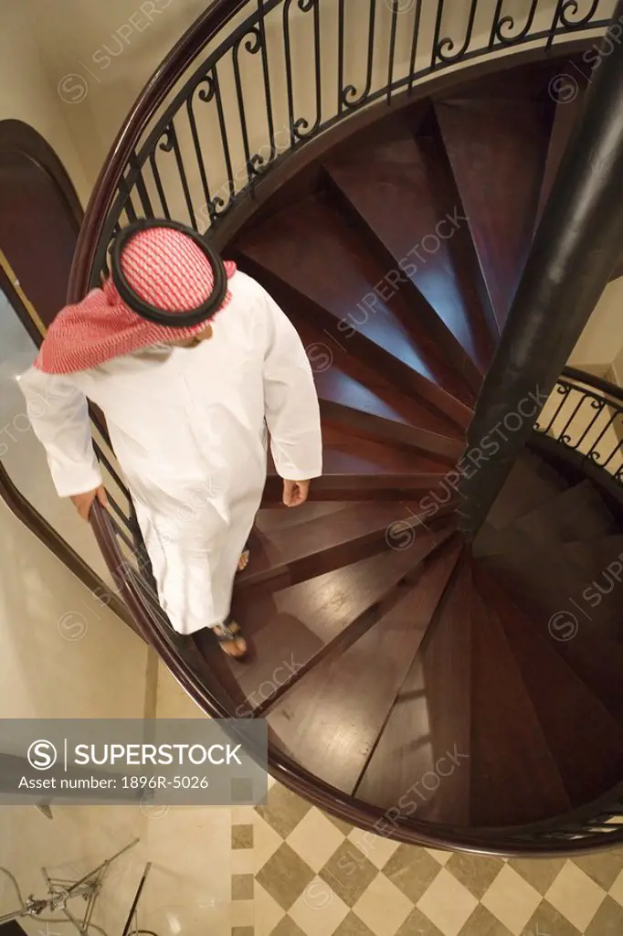 Arab Man Walking Down Winding Staircase  Dubai, United Arab Emirates