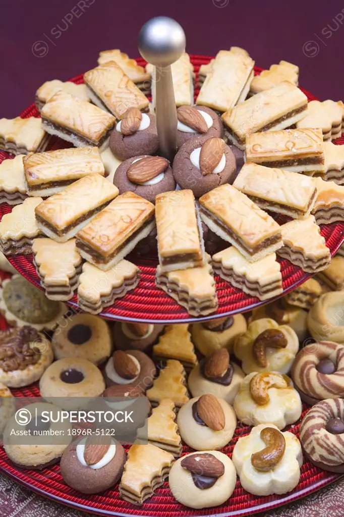 Arab sweets displayed on red platter  United Arab Emirates