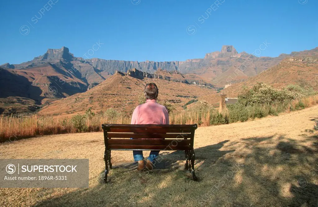 Tourist enjoying the view of the Drakensberg amphitheatre in KwaZulu Natal Province, South Africa
