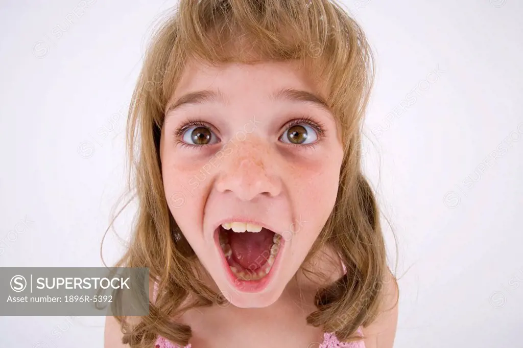 Young Girl Pulling a Funny Face at the Camera  Studio Shot