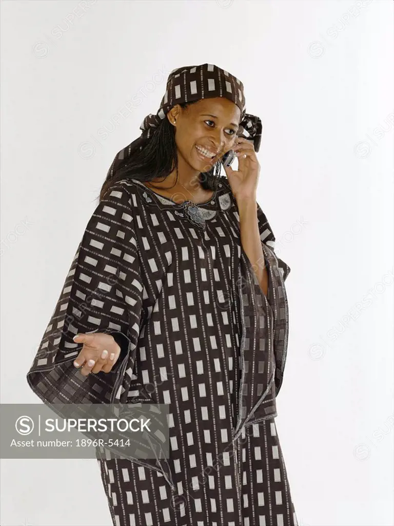 Nigerian Lady in Traditional Clothing Talking on Cell Phone  Studio Shot