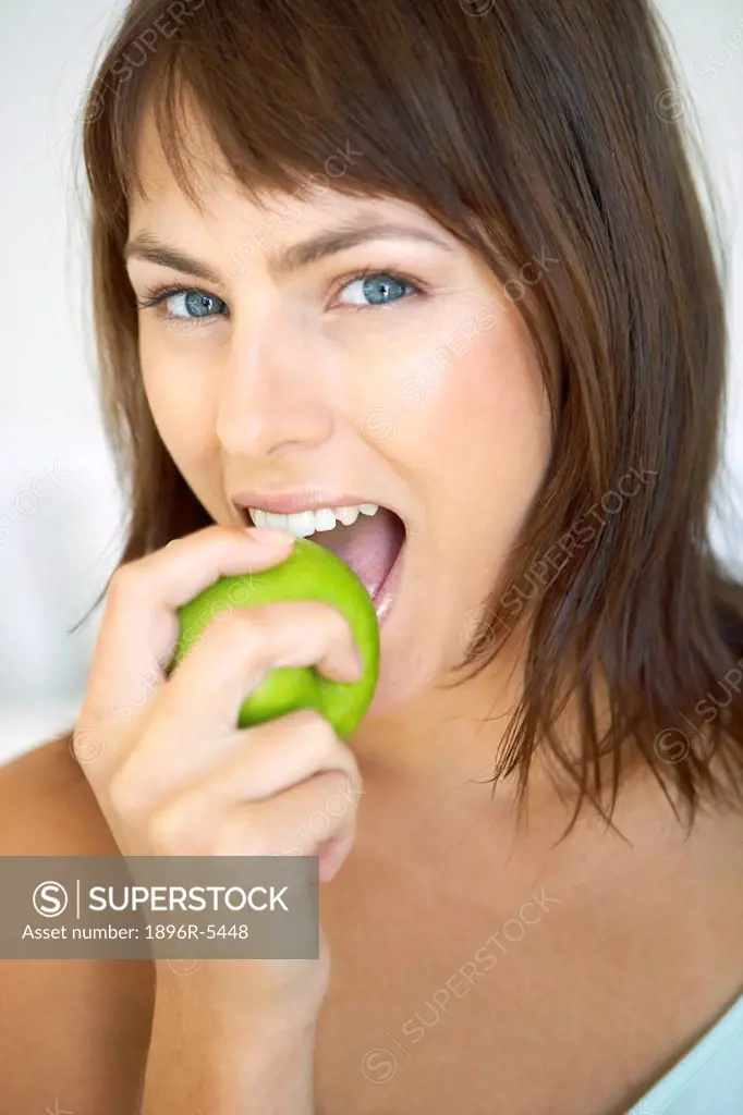 Woman Biting into a Green Apple  Cape Town, Western Cape Province, South Africa