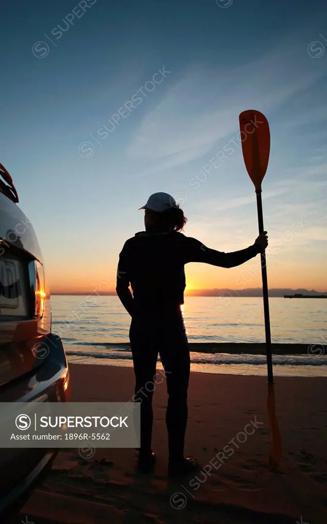 Silhouette of a Woman Holding an Oar at Sunset  Western Cape Province, South Africa
