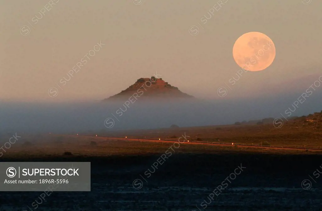 Moonset at dawn, over the N1 highway, Colesburg, South Africa