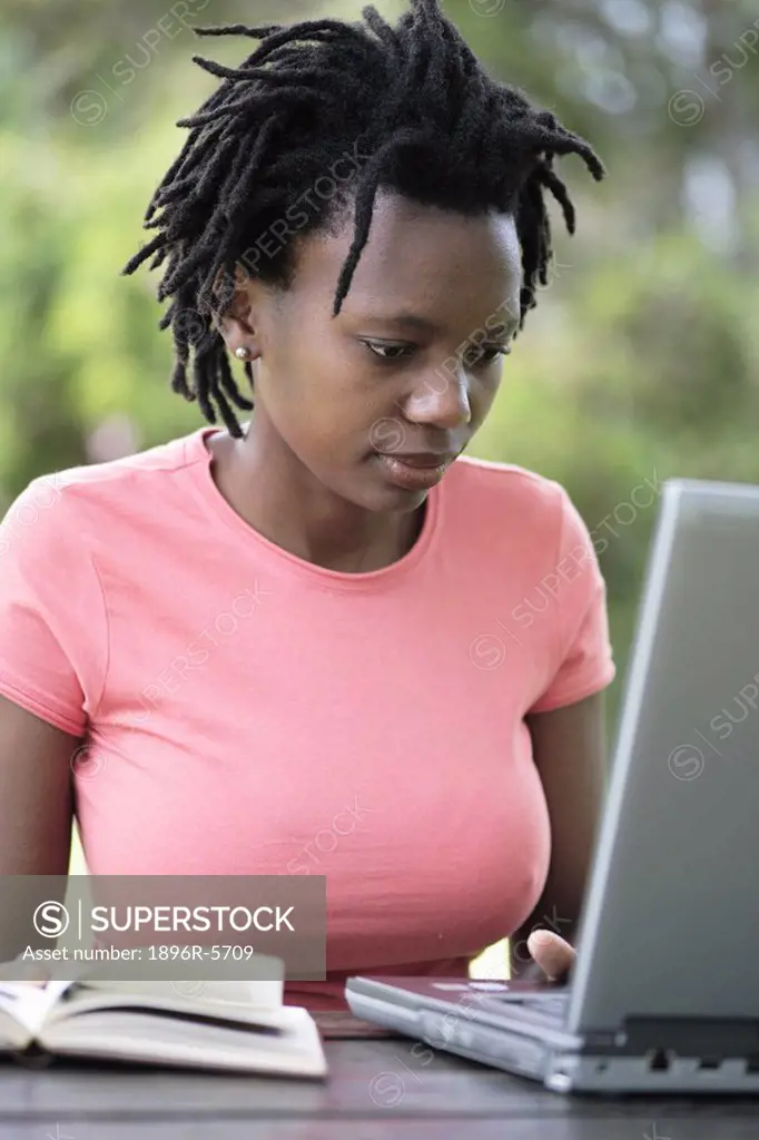 Young Woman working sitting outside Working on her Laptop  Grahamstown, Eastern Cape Province, South Africa
