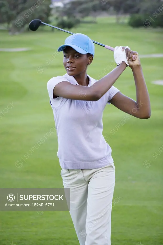 Front View of Woman With Golf Club  Clovelly Golf Course, Cape Town, Western Province, South Africa