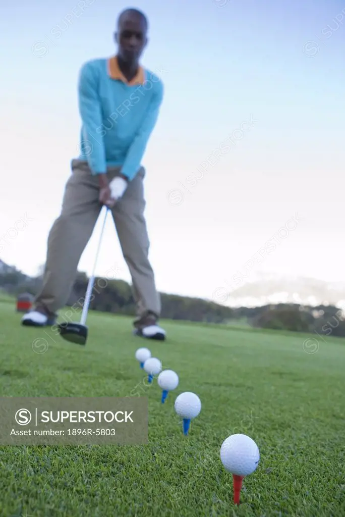 Man Addressing Golf Balls  Clovelly Golf Course, Cape Town, Western Province, South Africa