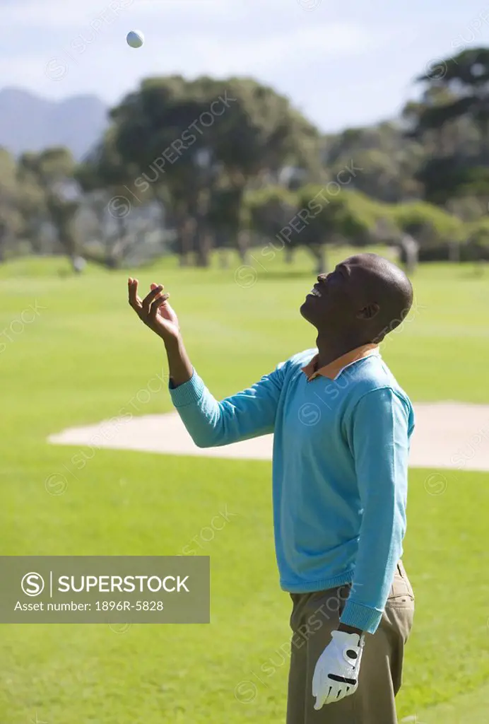 Man Throwing Golf Ball into the Air  Clovelly Golf Course, Cape Town, Western Province, South Africa