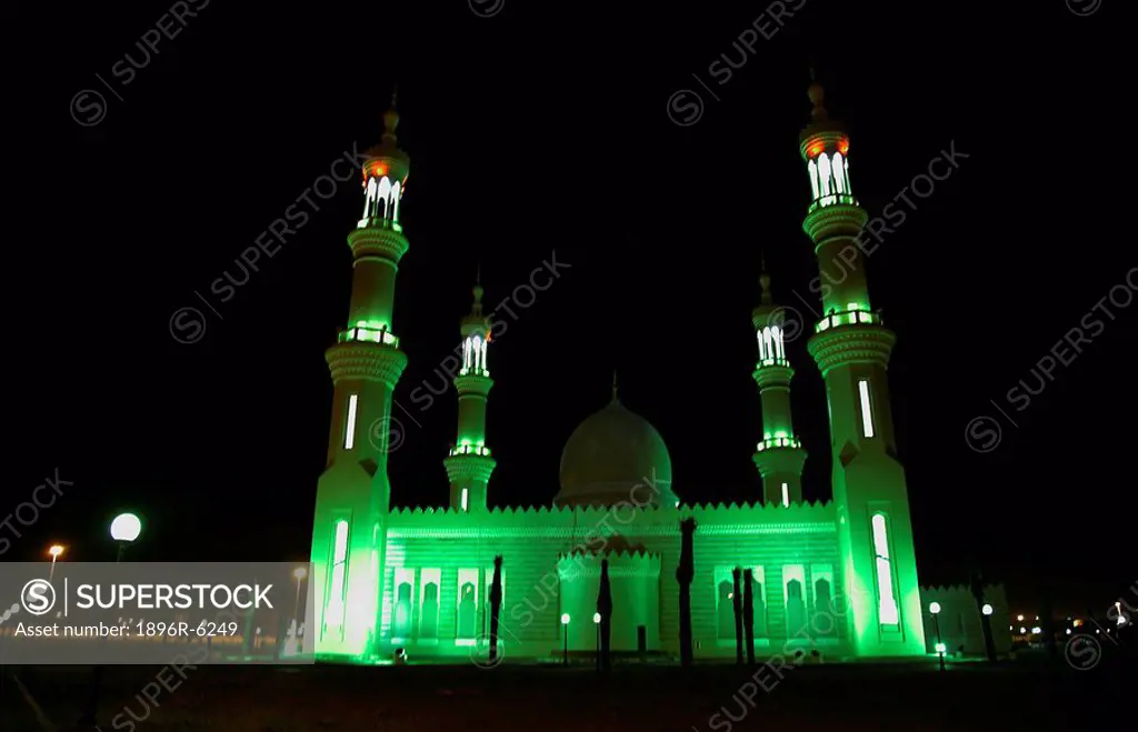 Green night lights of a Mosque in Dubai. Sharjah, United Arab Emirates