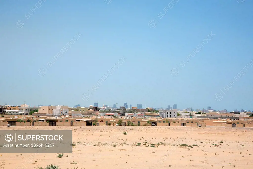 Residential area in Sharjah with the city skyline behind. Sharjah, Dubai, United Arab Emirates