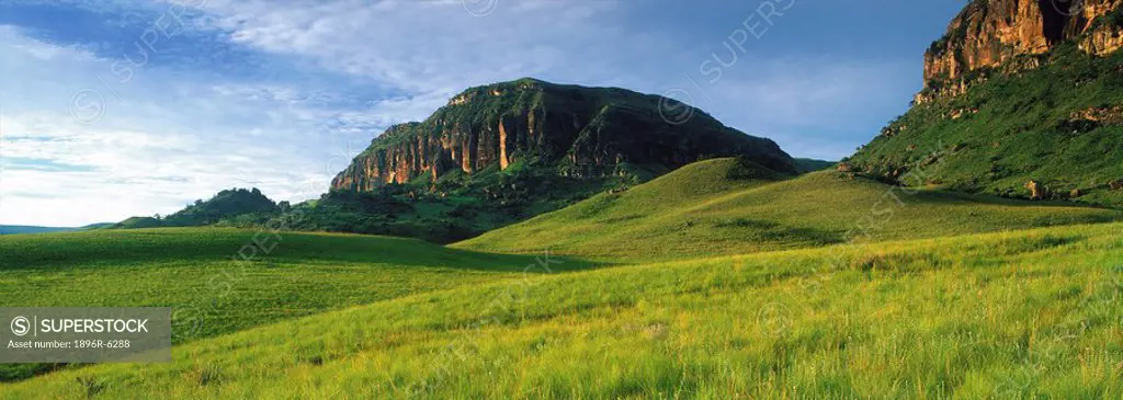 Lush emerald green summer scene of mountains and rolling hills in the Injasuti area. Central Drakensberg, KwaZulu Natal Province, South Africa