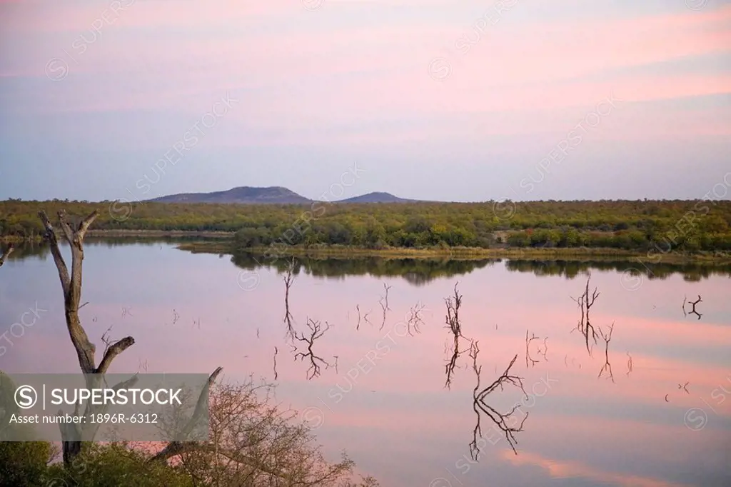 Sunset clouds over Pioneer Dam at Mopani Camp. Kruger National Park, Mpumalanga Province, South Africa