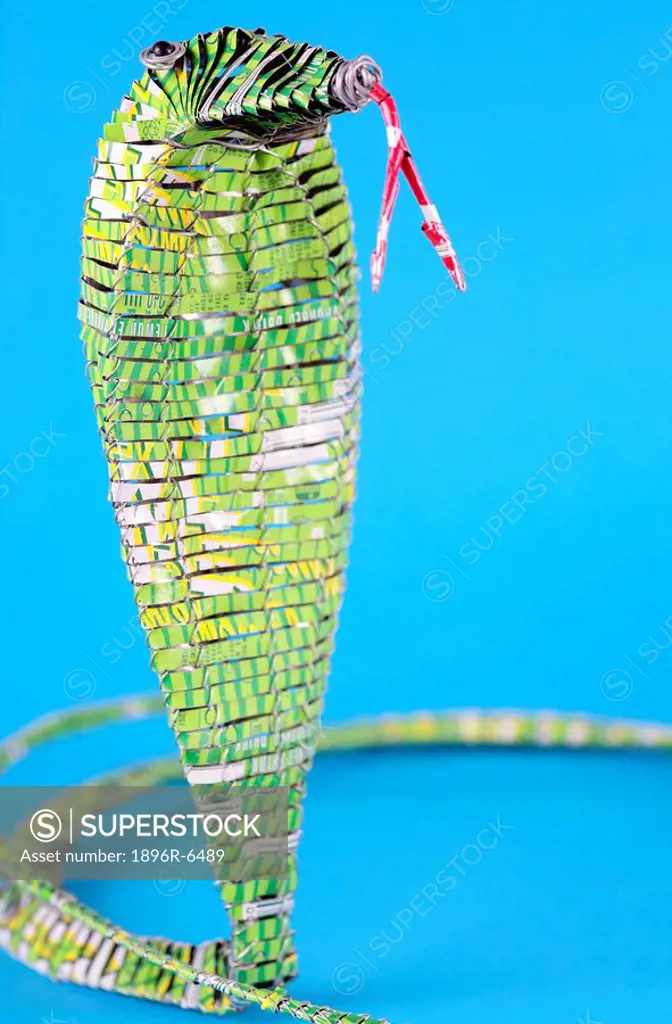 Green metal cobra snake made by recycling cool drink cans. Grahamstown, Eastern Cape Province, South Africa