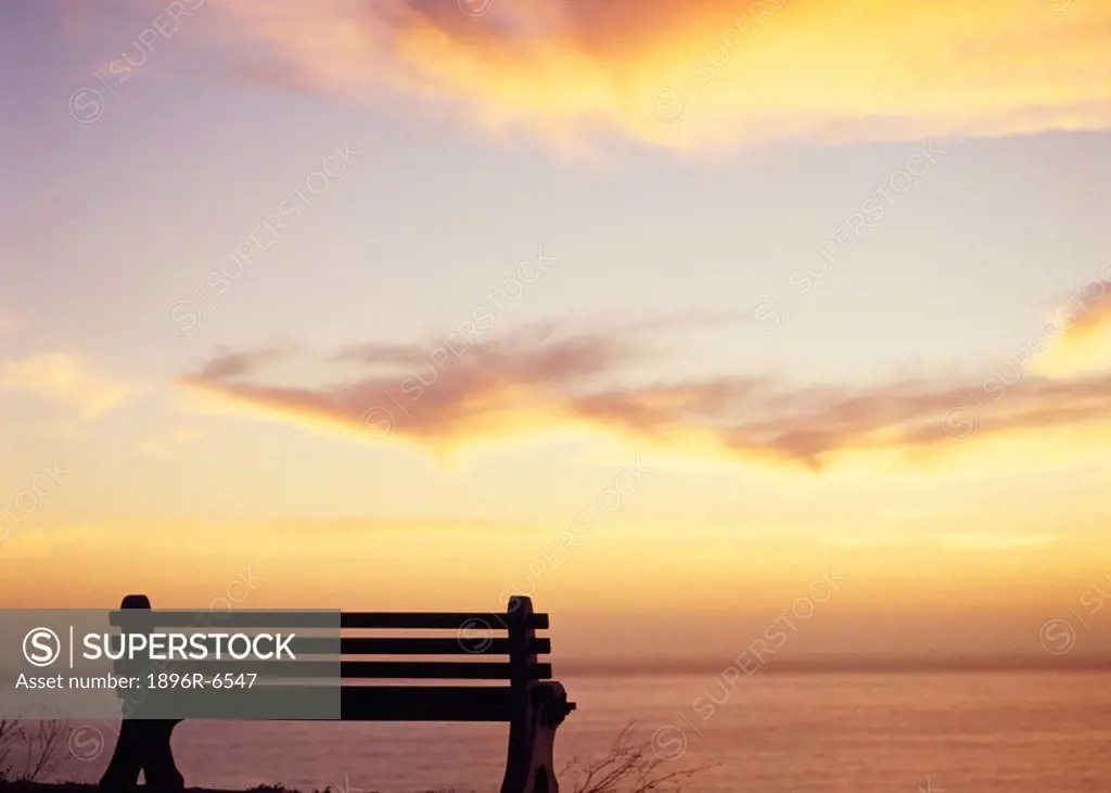 Bench at Sunset over the Atlantic Ocean off Clifton. Cape Peninsula, Cape Town, Western Cape Province, South Africa
