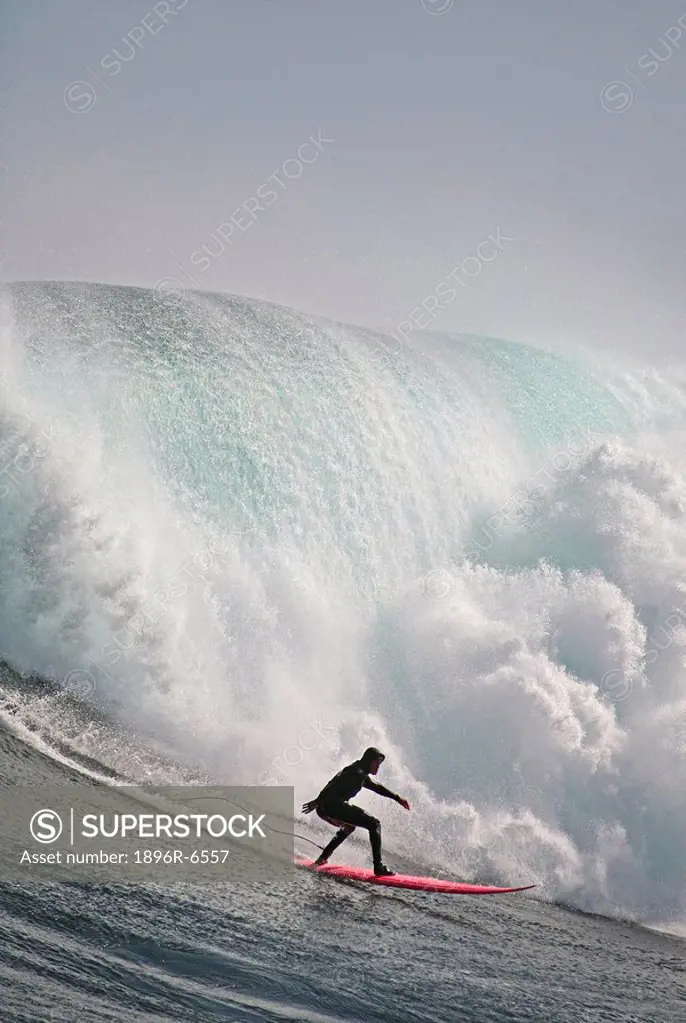 Surfer on a big wave that storms in from the Antarctic each year to hit the infamous offshore reef outside Hout Bay known as Dungeons. Cape Town, West...