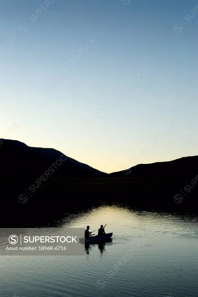 Fly fisherman fishing from a rowboat, Kwazulu Natal Midlands Province, South Africa