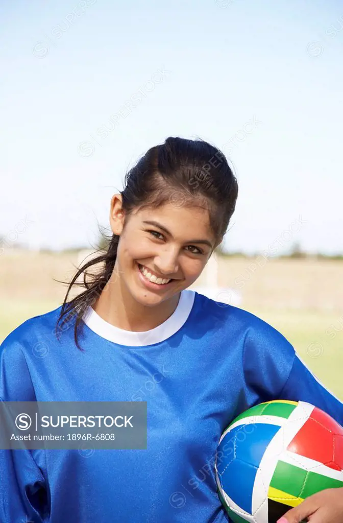 Woman smiling holding a ball with South African colours. Cape Town, Western Cape Province, South Africa