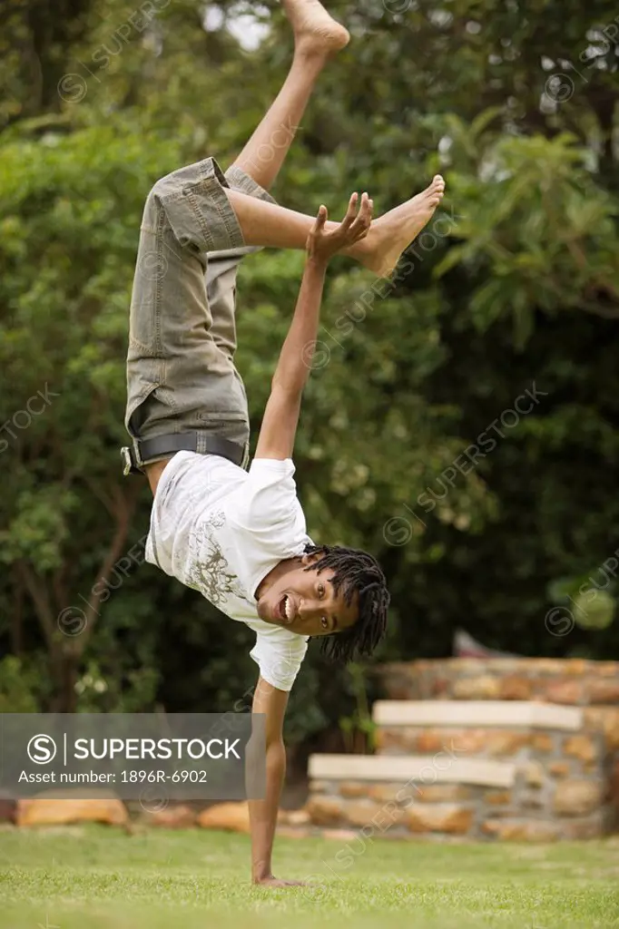 South African teen culture _ Young male break_dancer balancing on one hand.
