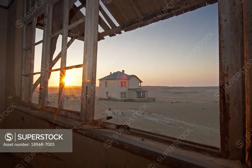 Sun shines into deserted ghost house. Kolmanskop, Namibia.