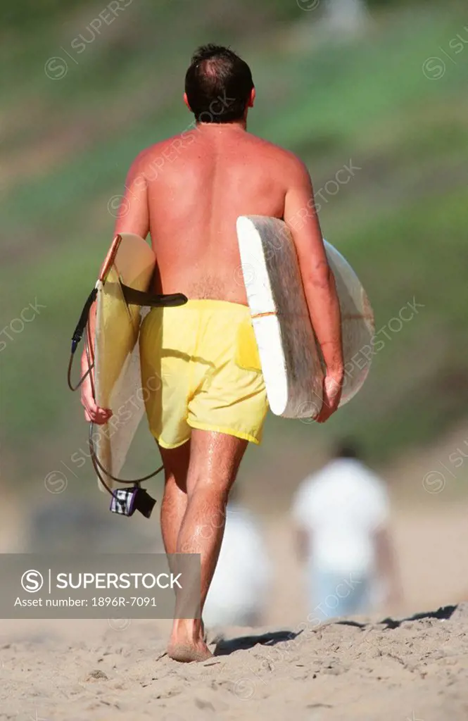 Surfer Walking on the Beach With His Broken Surfboard Under His Arms  South Coast, Kwa-Zulu Natal Province, South Africa