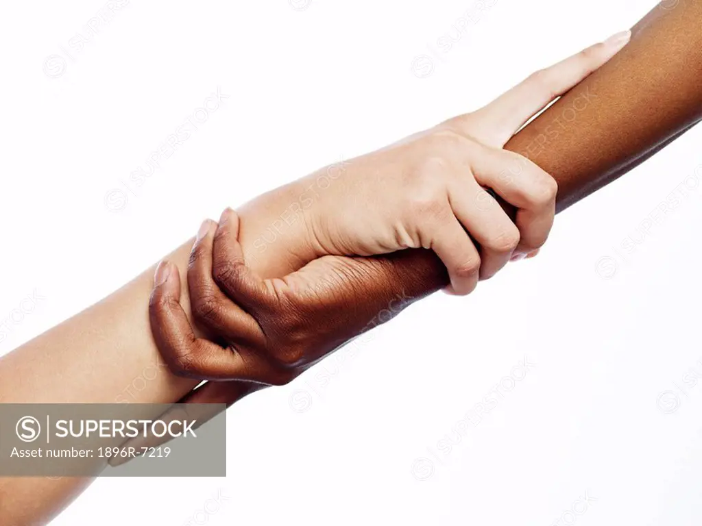 African and Caucasian Woman with their Hands Interlocked  Studio Shot