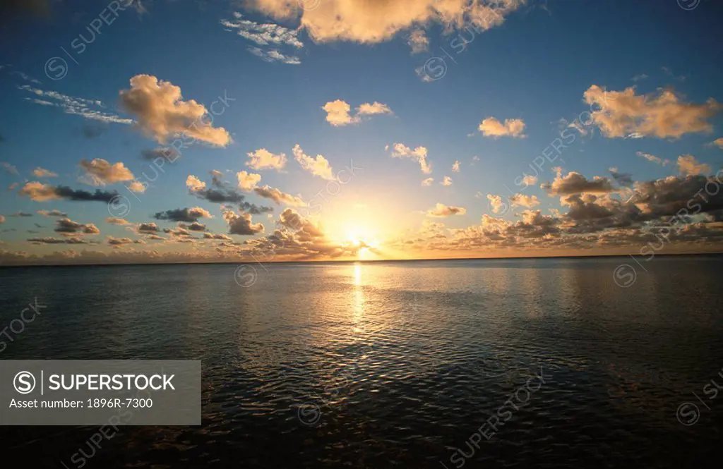 Scenic View of the Sun Setting over the Calm Ocean  Teachopoo Island, Tahiti, South Pacific Islands
