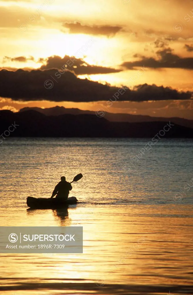 Silhouette of a Paddler on a Lake at Sunset  Lake Titicaca, Copacabana, Bolivia