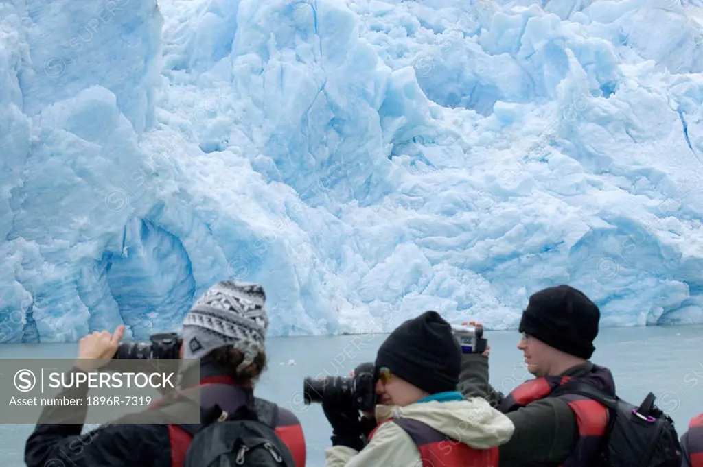 Rear View of Tourists on a Boat Photographing Glacier Grey  Torres del Paine National Park, Chile, South America