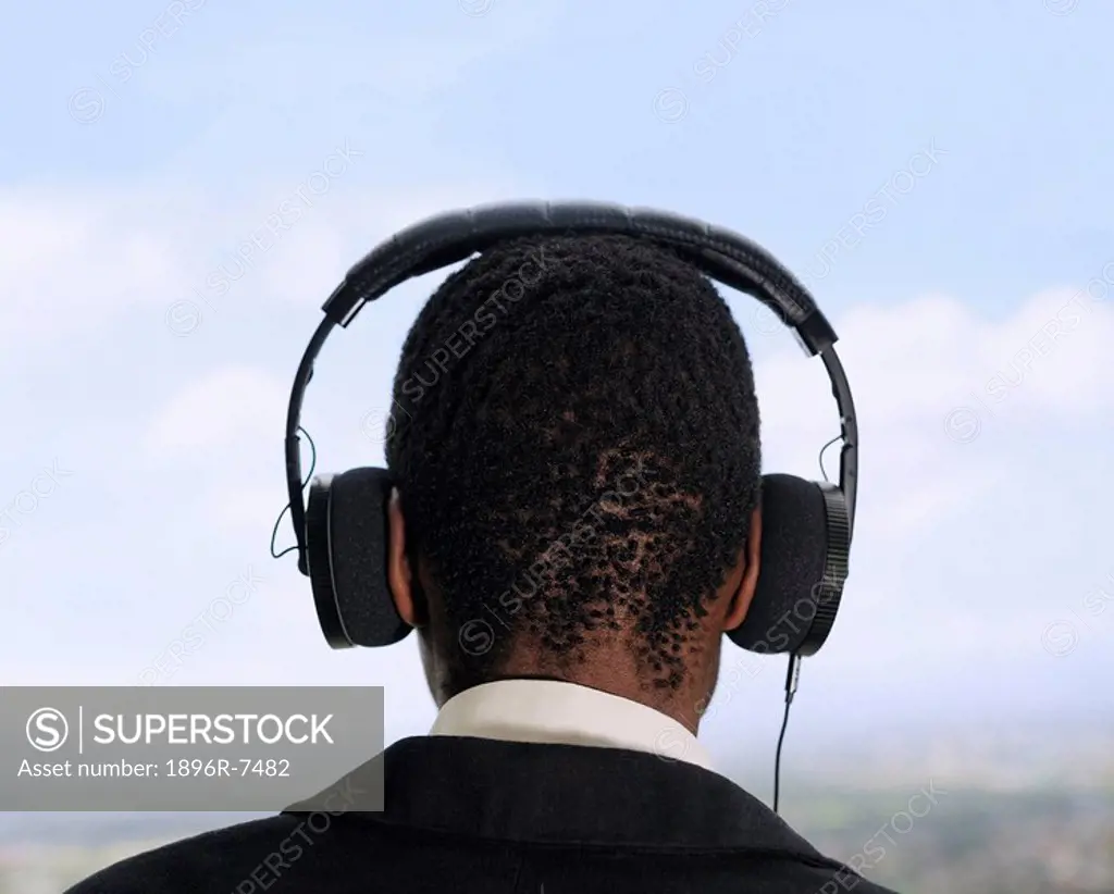 Rear view of black man wearing headphones, Cape Town, Western Cape Province, South Africa
