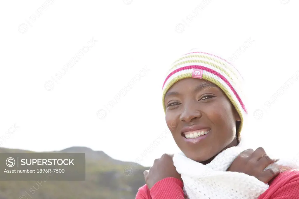 Woman wearing beanie and scarf smiling outdoors, Cape Town, Western Cape Province, South Africa