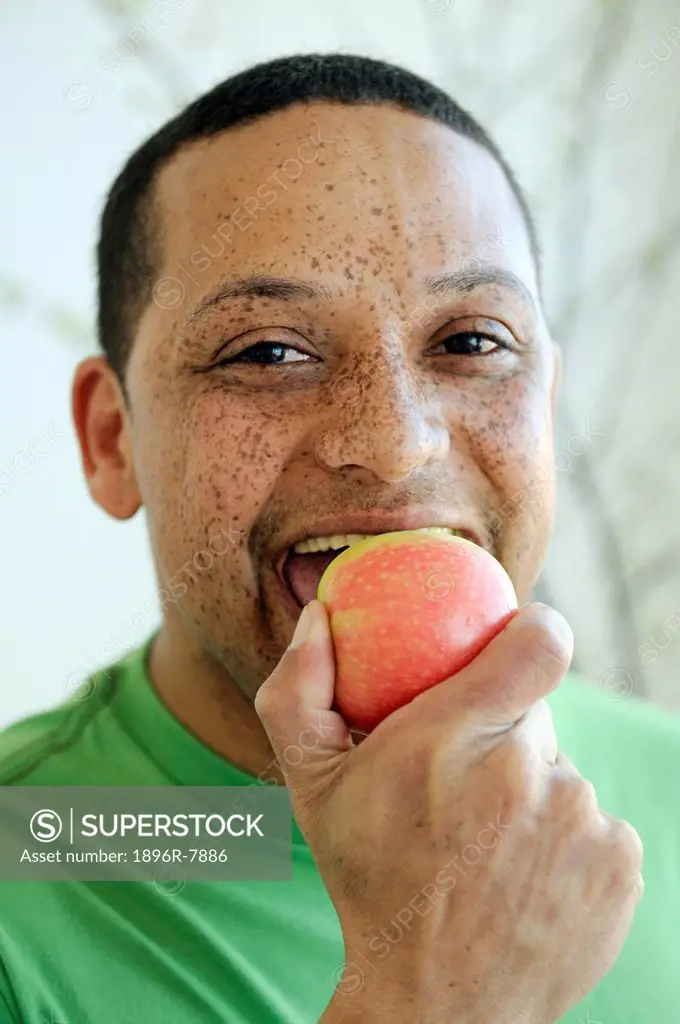 Man with freckles eating apple, Cape Town, Western Cape Province, South Africa