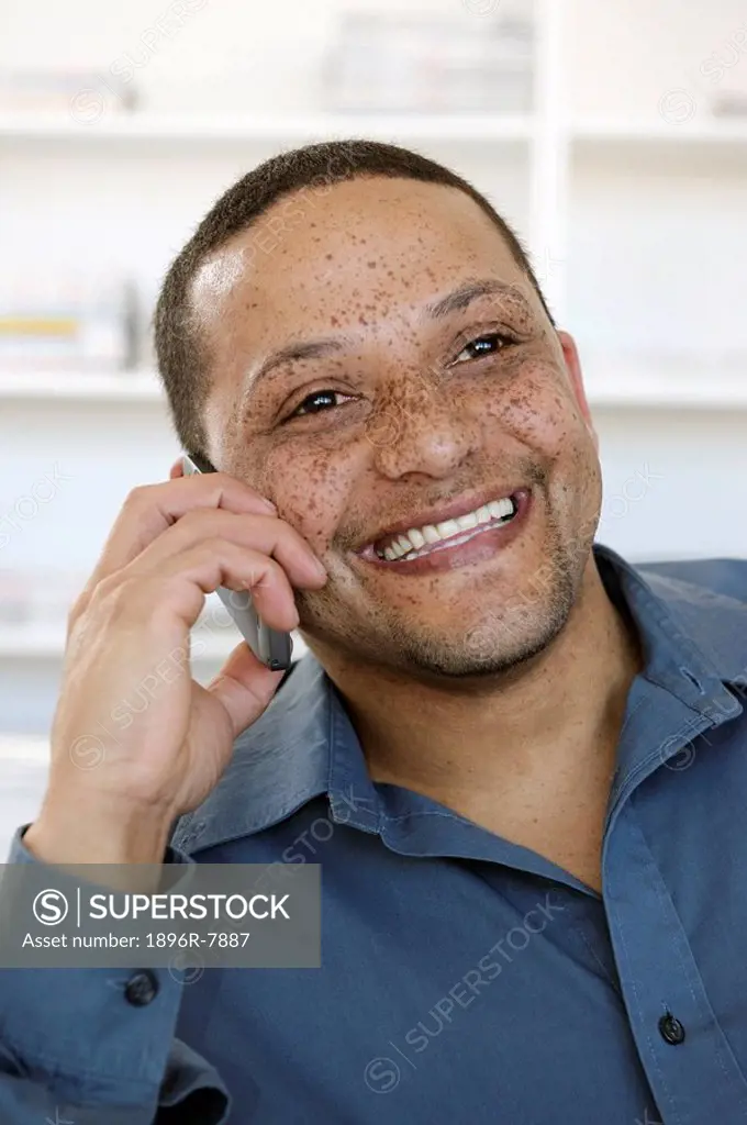 Man with freckles using mobile phone, Cape Town, Western Cape Province, South Africa